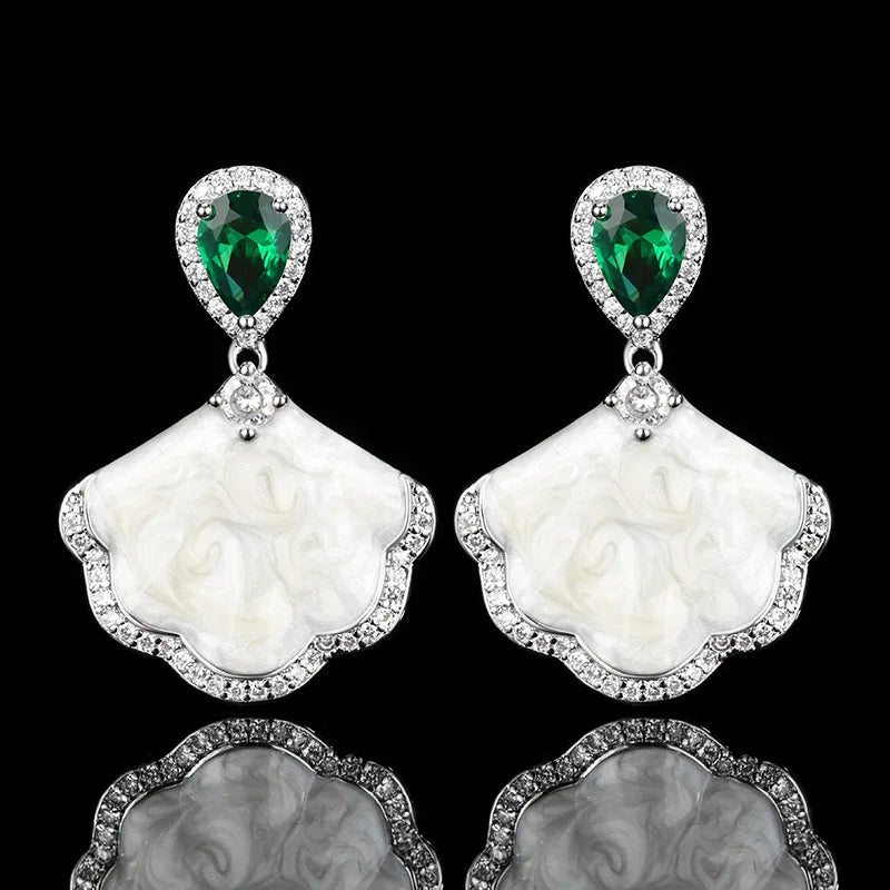 Luxury high-quality earrings made from natural shell and sparkling zircon.