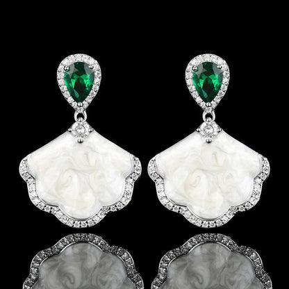 Luxury high-quality earrings made from natural shell and sparkling zircon.