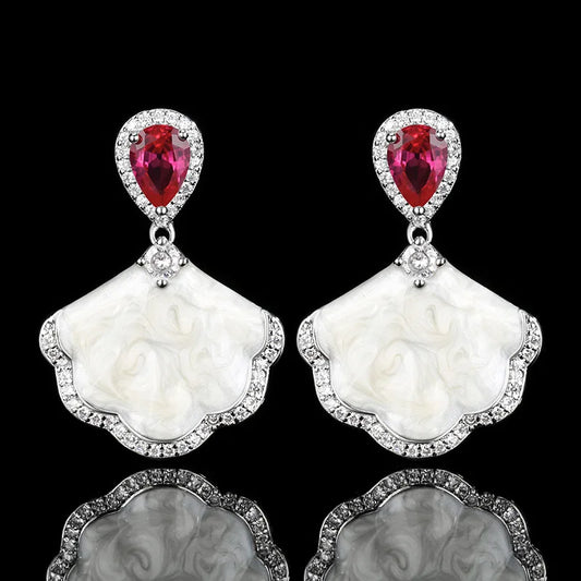 Luxury high-quality earrings made from natural shell and sparkling zircon.