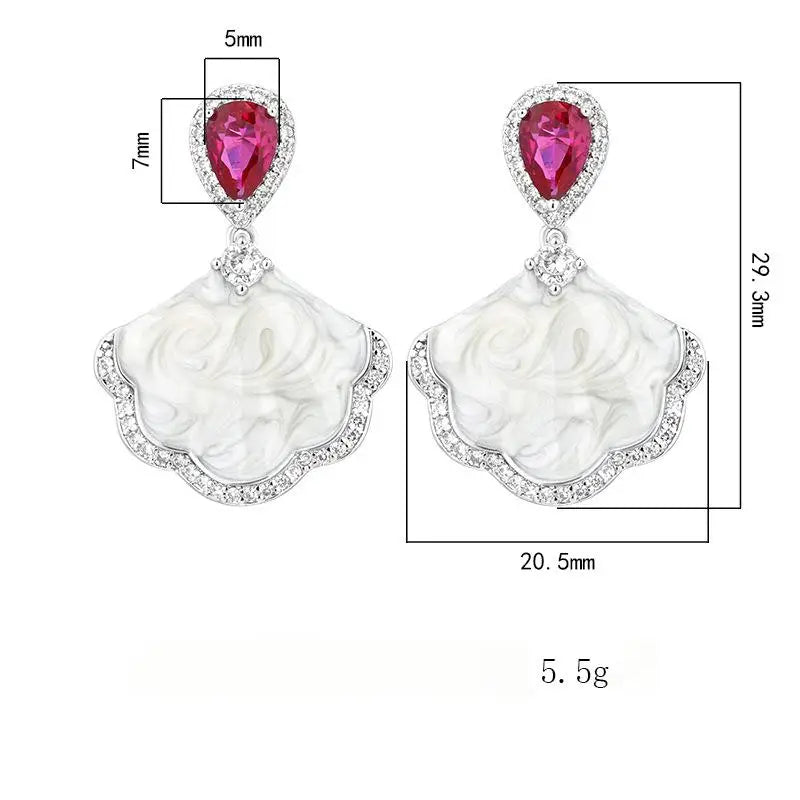 Luxury high-quality earrings made from natural shell and sparkling zircon.