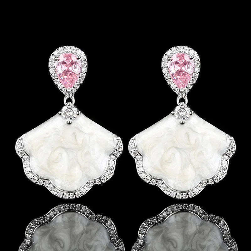 Luxury high-quality earrings made from natural shell and sparkling zircon.