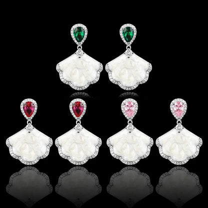 Luxury high-quality earrings made from natural shell and sparkling zircon.