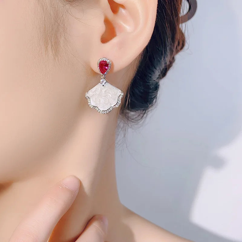 Luxury high-quality earrings made from natural shell and sparkling zircon.