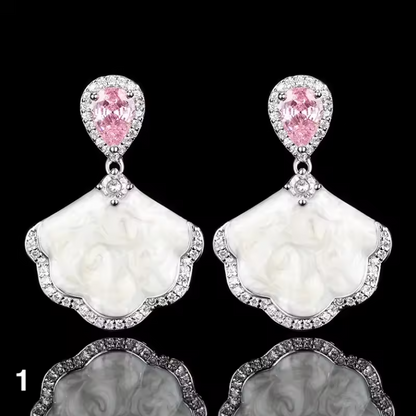 Luxury high-quality earrings made from natural shell and sparkling zircon.