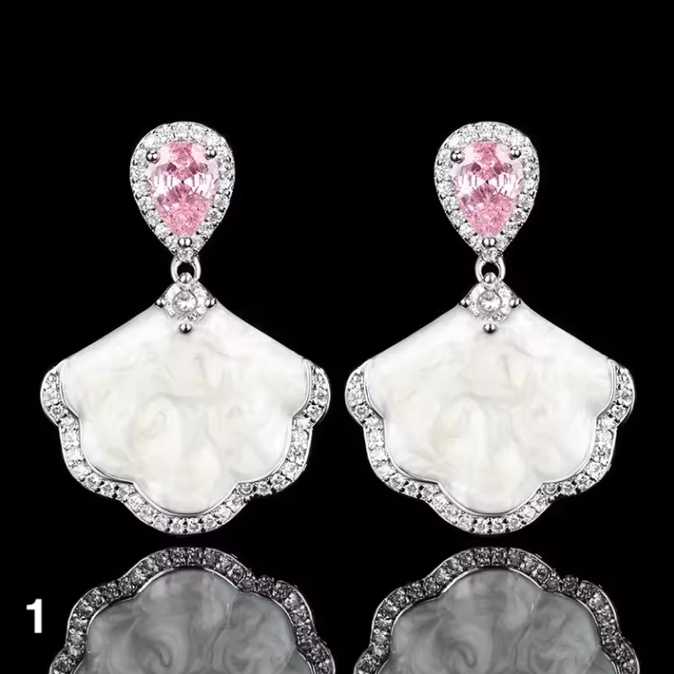 Luxury high-quality earrings made from natural shell and sparkling zircon.