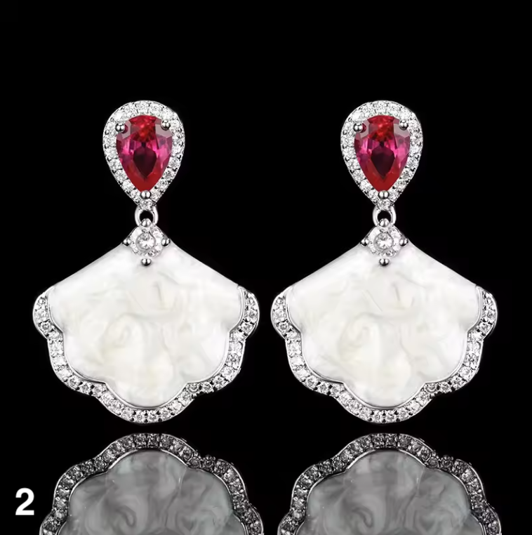 Luxury high-quality earrings made from natural shell and sparkling zircon.
