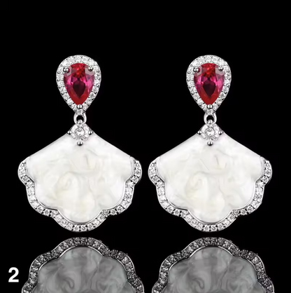 Luxury high-quality earrings made from natural shell and sparkling zircon.