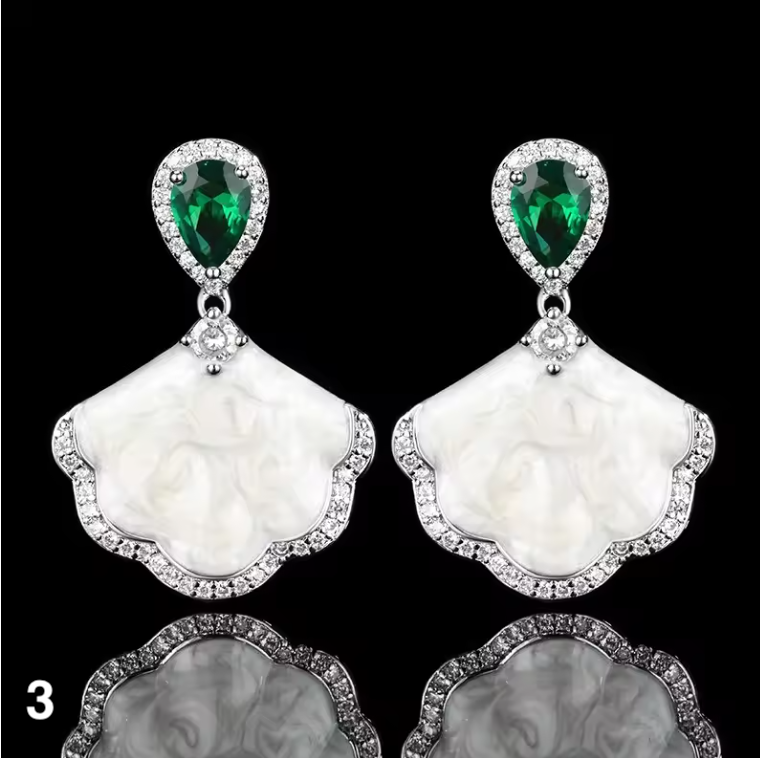Luxury high-quality earrings made from natural shell and sparkling zircon.