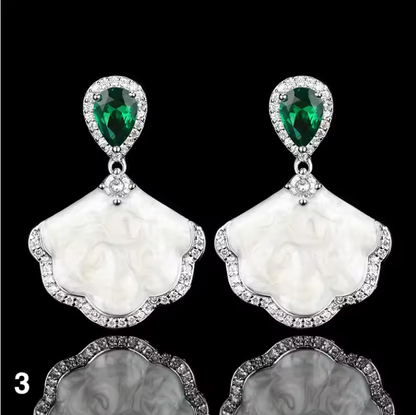 Luxury high-quality earrings made from natural shell and sparkling zircon.