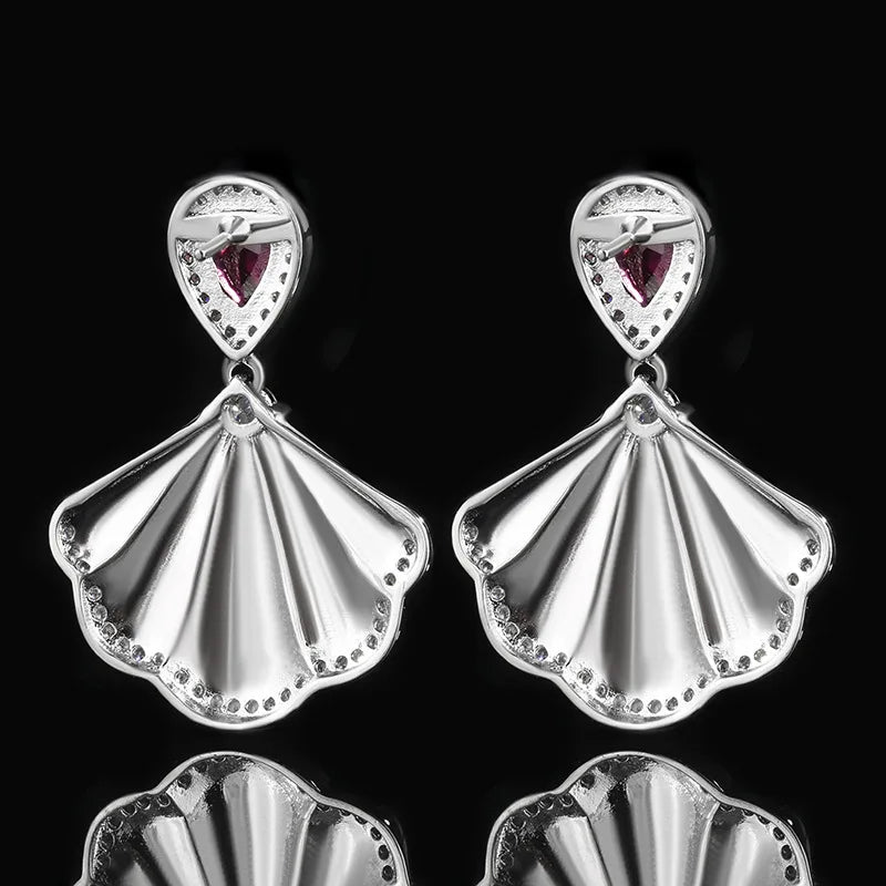 Luxury high-quality earrings made from natural shell and sparkling zircon.