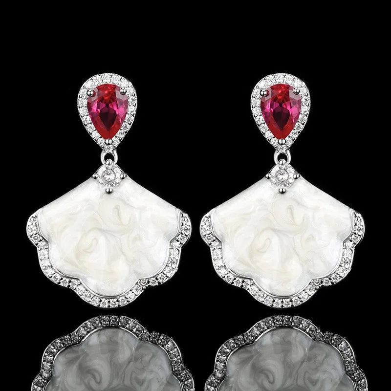 Luxury high-quality earrings made from natural shell and sparkling zircon.