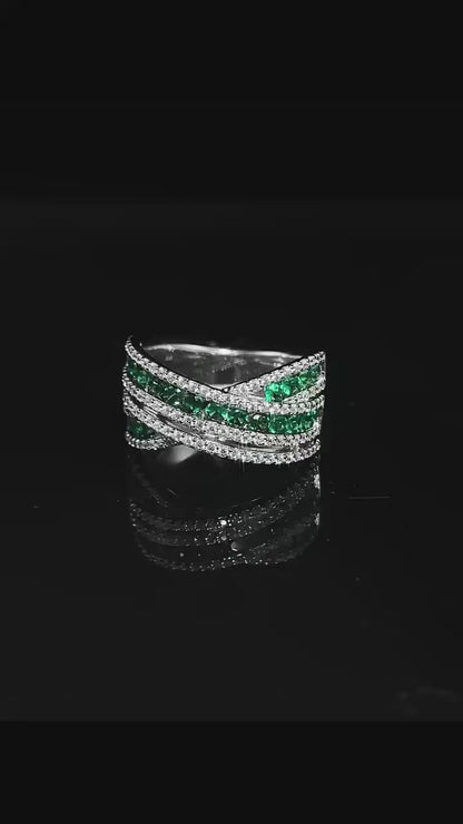 An exquisite X-shaped ring, crafted from 925 sterling silver and set with dazzling emerald gemstones. A timeless piece that reflects elegance and sophistication.