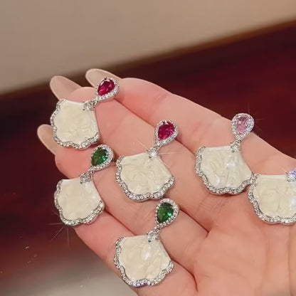 Luxury high-quality earrings made from natural shell and sparkling zircon.